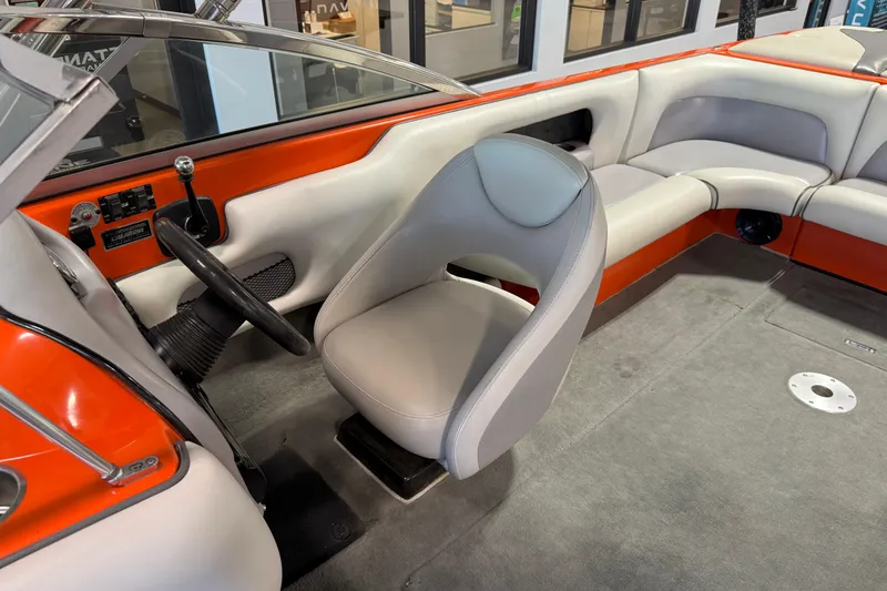 Slide: The Image of 2005 Calabria PRO V boat interior with orange accents and gray seating. - 14