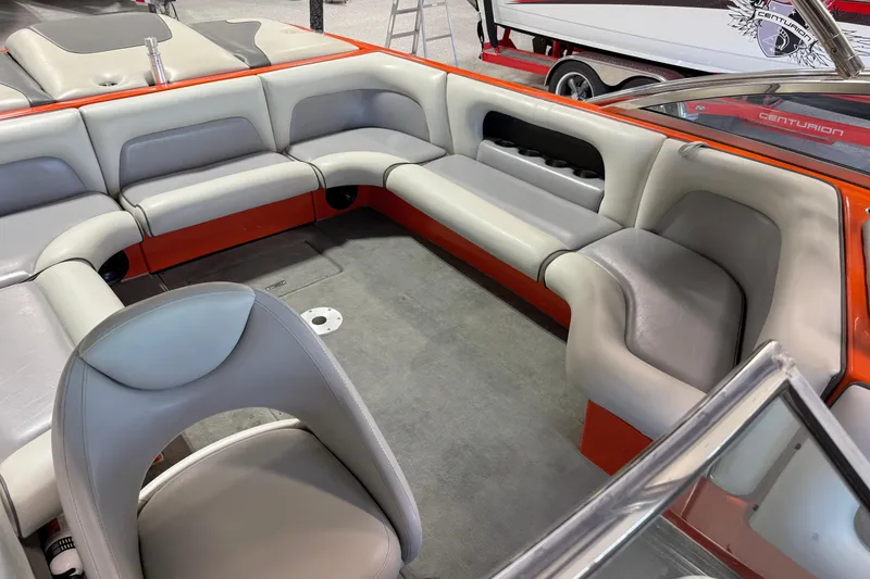 Slide: The Image of 2005 Calabria PRO V boat interior with gray and orange seating, featuring cup holders and carpeted floor. - 16