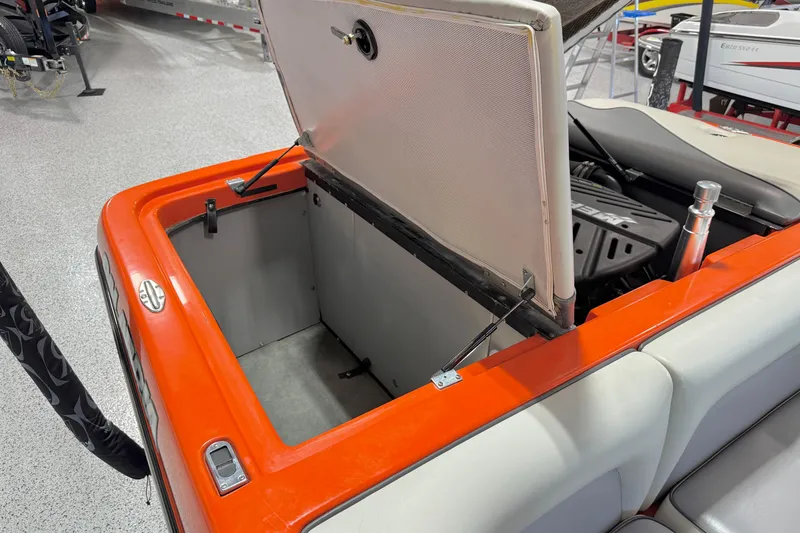 Slide: The Image of Open storage compartment in 2005 Calabria PRO V boat with visible engine. - 21