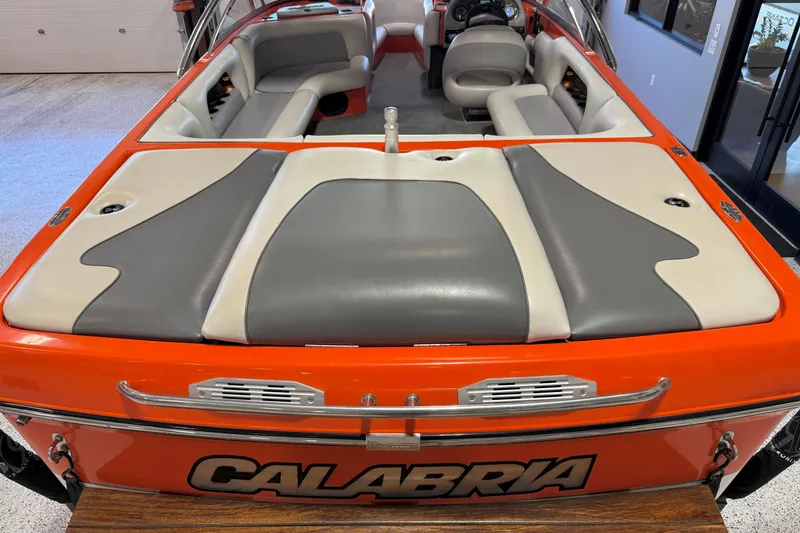 Slide: The Image of 2005 Calabria PRO V boat interior with gray and white seating, orange exterior. - 22