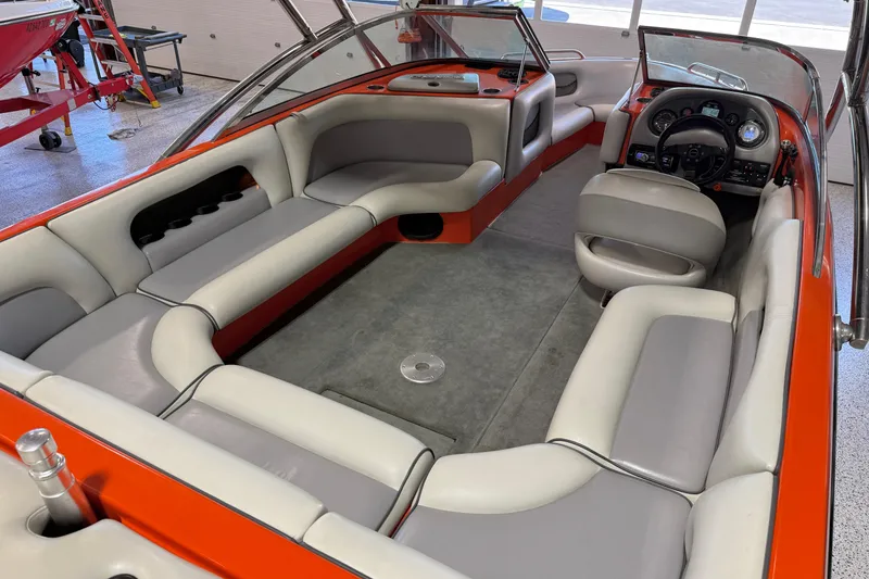 Slide: The Image of 2005 Calabria PRO V boat interior with gray and orange seating, steering wheel, and dashboard. - 24