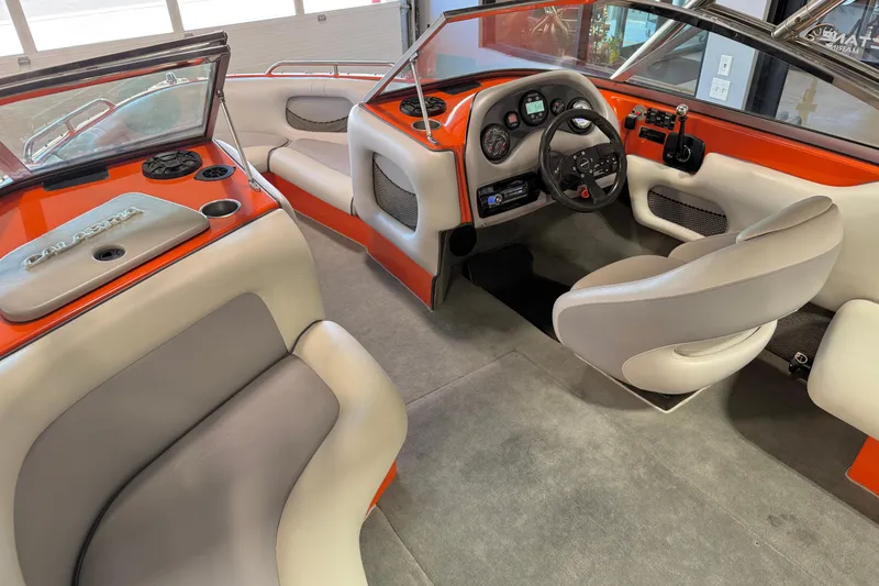 Slide: The Image of 2005 Calabria PRO V boat interior with orange accents and modern dashboard design. - 25