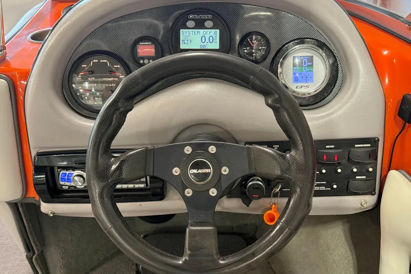 Slide: The Image of 2005 Calabria PRO V boat dashboard with steering wheel and instrument panel. - 27