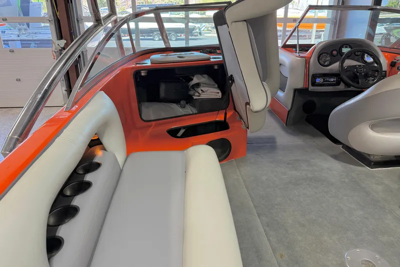 Slide: The Image of Interior of a 2005 Calabria PRO V boat with orange and gray seating. - 28