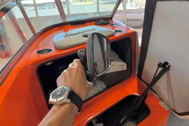 Slide: The Image of Interior of a 2005 Calabria PRO V boat with orange dashboard and rearview mirror. - 30