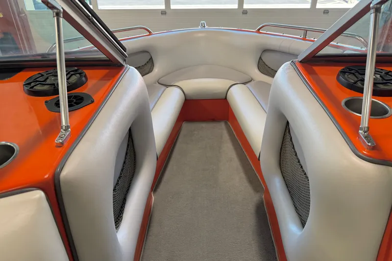 Slide: The Image of Interior of a 2005 Calabria PRO V boat with orange and white seating. - 31