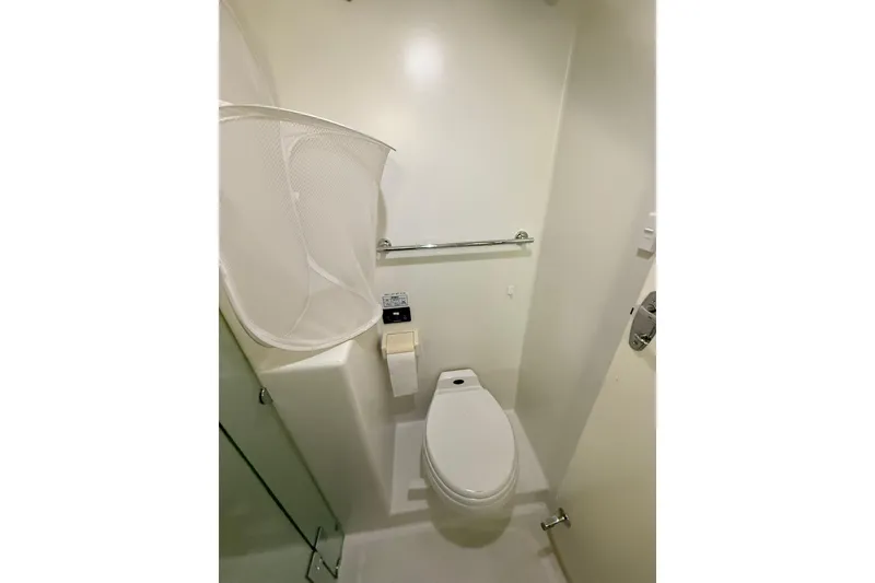 Slide: The Image of Bathroom interior of 2002 Norris Custom Motor Catamaran 41.4 with toilet and laundry basket. - 103