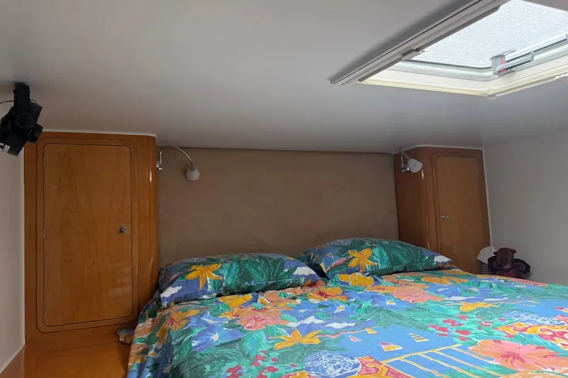 Slide: The Image of Cozy bedroom in 2002 Norris Custom Motor Catamaran 41.4 with floral bedding and skylight. - 104