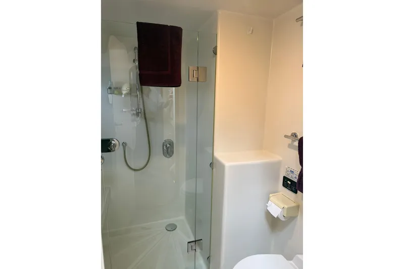 Slide: The Image of Modern bathroom in 2002 Norris Custom Motor Catamaran 41.4, featuring glass shower and sleek fixtures. - 107