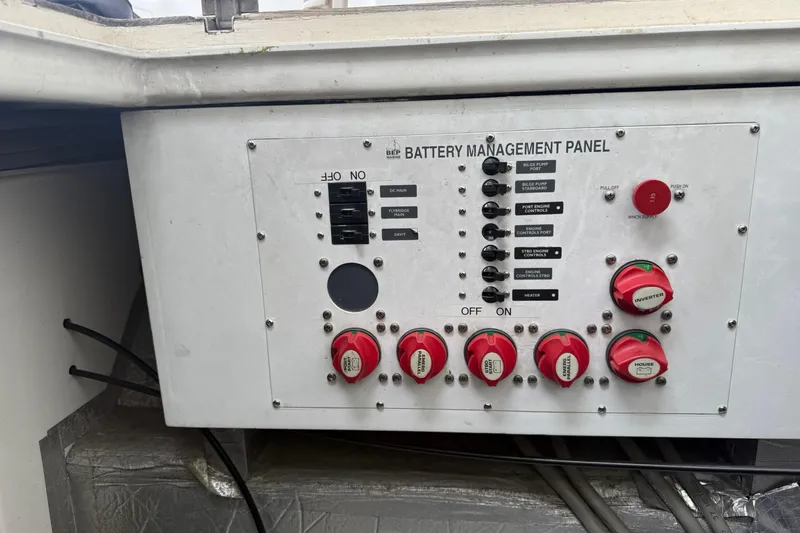 Slide: The Image of Battery management panel on 2002 Norris Custom Motor Catamaran 41.4, featuring switches and controls. - 116