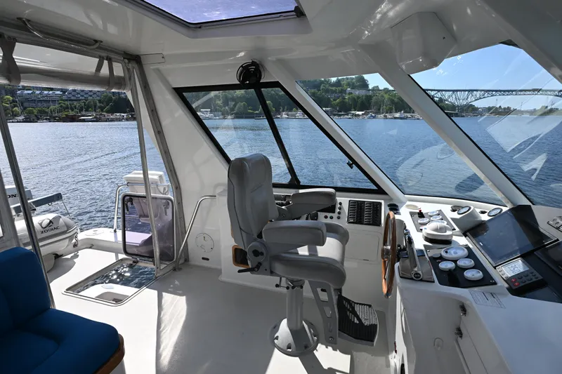 Slide: The Image of Interior view of a 2002 Roger Hill Power Cat 41.4, featuring helm and panoramic windows. - 33