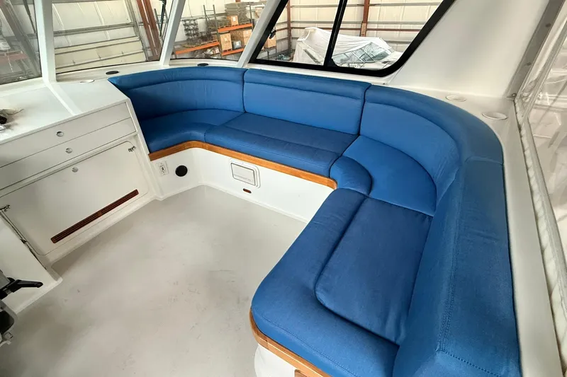 Slide: The Image of Interior of 2002 Norris Custom Motor Catamaran 41.4 with blue cushioned seating. - 37