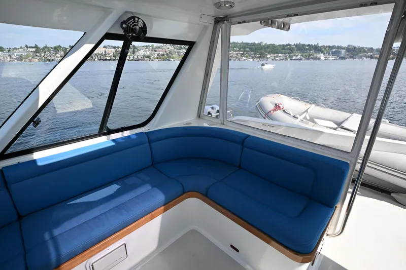 Slide: The Image of Interior of 2002 Roger Hill Power Cat 41.4 with blue seating and scenic water view. - 40