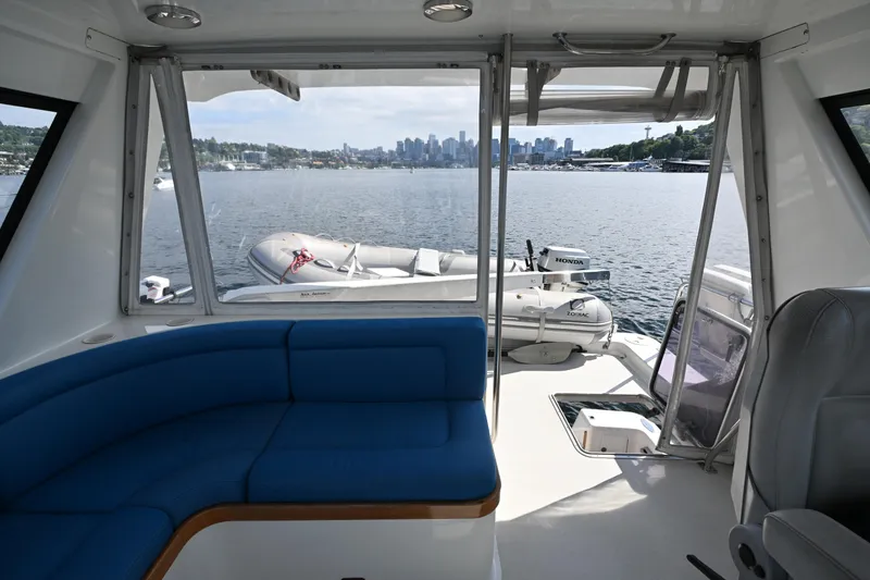 Slide: The Image of Interior view of 2002 Roger Hill Power Cat 41.4, featuring blue seating and scenic waterfront. - 41