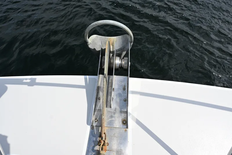Slide: The Image of Anchor mechanism on 2002 Roger Hill Power Cat 41.4, above calm water. - 48