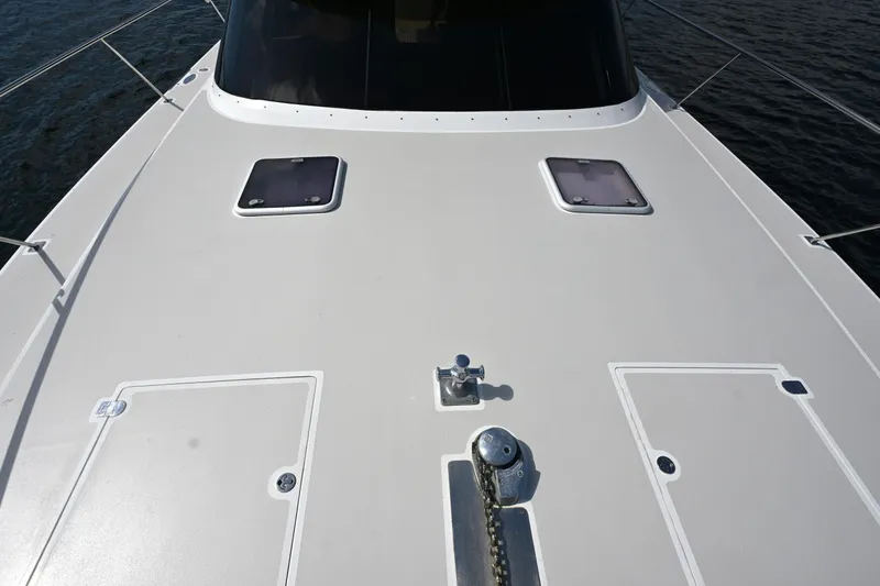 Slide: The Image of Deck view of 2002 Roger Hill Power Cat 41.4, featuring hatches and anchor chain. - 51