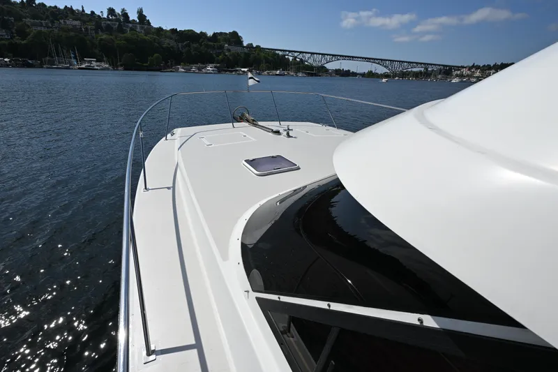 Slide: The Image of 2002 Roger Hill Power Cat 41.4 on calm water with scenic bridge view. - 53