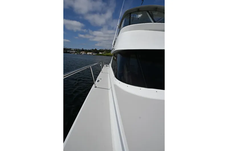 Slide: The Image of 2002 Roger Hill Power Cat 41.4 on water, showcasing sleek design and spacious deck. - 55