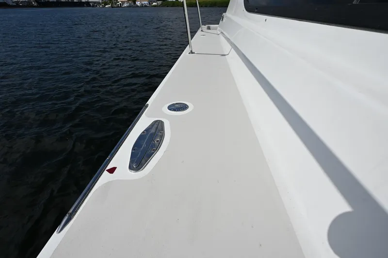 Slide: The Image of Deck view of 2002 Roger Hill Power Cat 41.4, showcasing sleek design and water backdrop. - 56