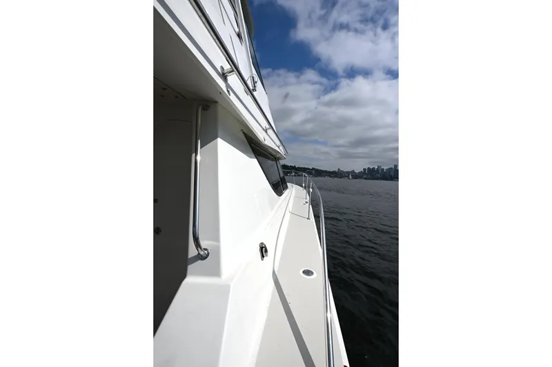 Slide: The Image of Side view of 2002 Roger Hill Power Cat 41.4 on water under cloudy sky. - 58