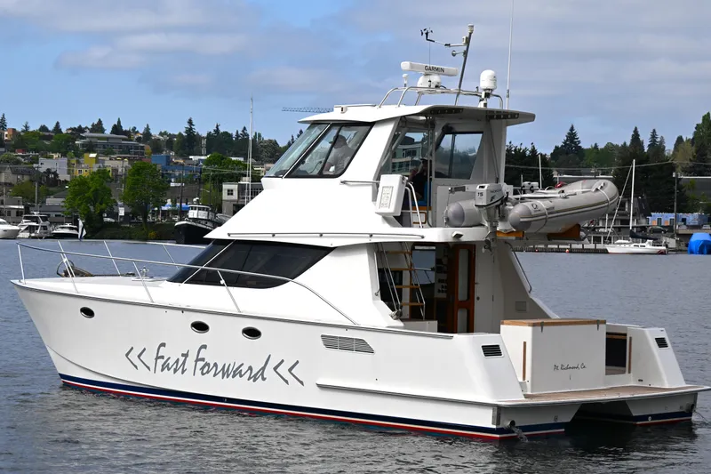 Slide: The Image of 2002 Roger Hill Power Cat 41.4 yacht on water, featuring sleek design and modern amenities. - 6