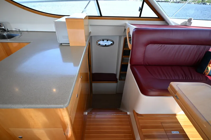Slide: The Image of Luxurious interior of 2002 Roger Hill Power Cat 41.4 with leather seating and wooden finishes. - 68