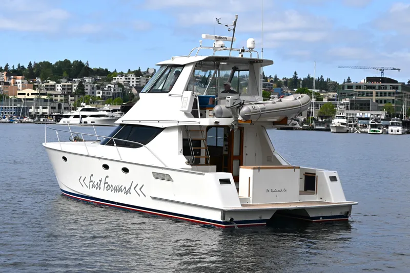 Slide: The Image of 2002 Roger Hill Power Cat 41.4 yacht docked in a marina, featuring sleek design and modern amenities. - 7