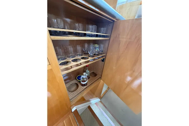 Slide: The Image of Wooden cabinet with glassware and a bottle on a 2002 Norris Custom Motor Catamaran 41.4. - 71