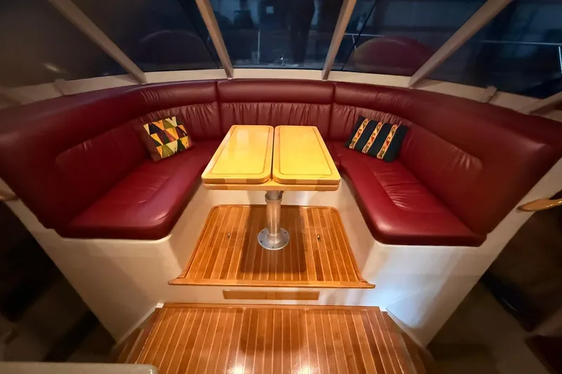 Slide: The Image of Luxurious interior of 2002 Norris Custom Motor Catamaran 41.4 with red leather seating and wooden table. - 78