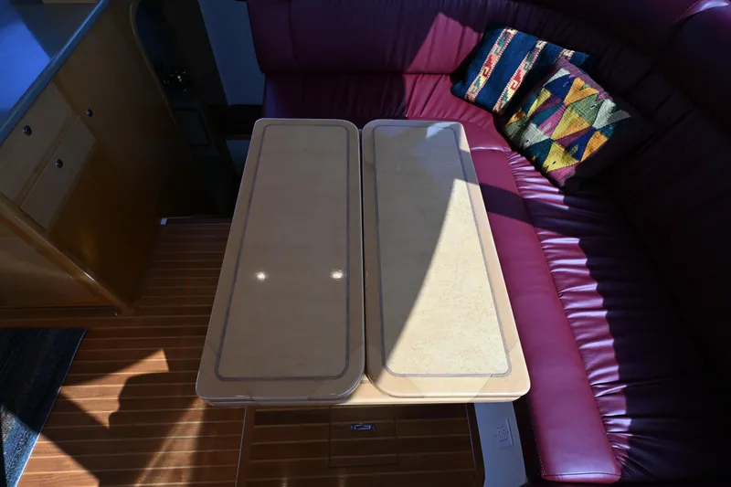 Slide: The Image of Luxurious interior of 2002 Roger Hill Power Cat 41.4 with wooden table and plush seating. - 80