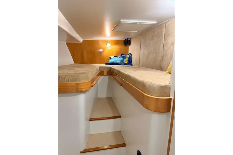 Slide: The Image of Cozy cabin interior of 2002 Norris Custom Motor Catamaran 41.4 with twin beds and wooden accents. - 89