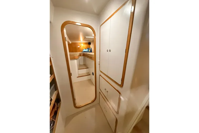 Slide: The Image of Interior of 2002 Norris Custom Motor Catamaran 41.4, featuring wooden trim and storage cabinets. - 90