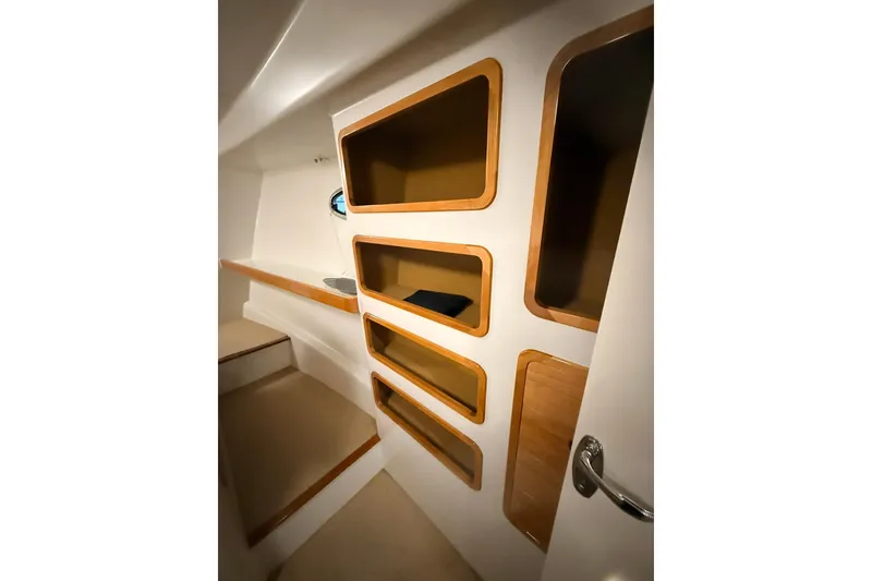 Slide: The Image of Interior of 2002 Norris Custom Motor Catamaran 41.4, featuring wooden shelves and modern design. - 97