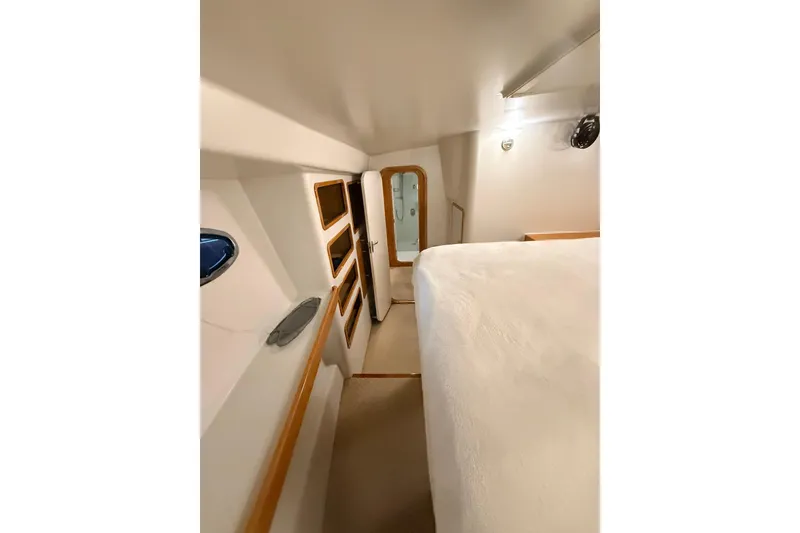 Slide: The Image of Interior of 2002 Norris Custom Motor Catamaran 41.4, featuring cozy cabin and wooden accents. - 99
