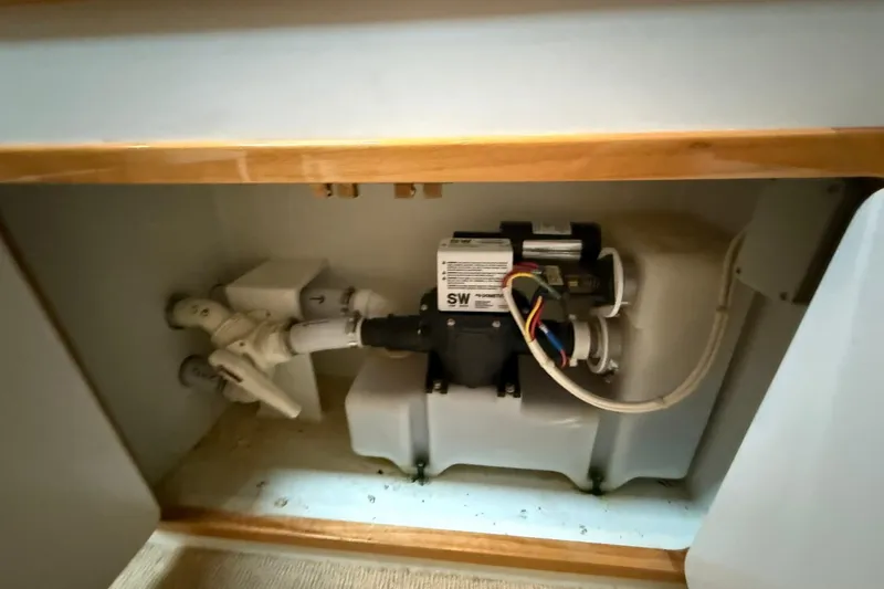 Slide: The Image of Engine compartment of a 2002 Norris Custom Motor Catamaran 41.4, showcasing mechanical components. - 103