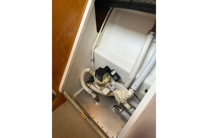 Slide: The Image of Engine compartment of 2002 Norris Custom Motor Catamaran 41.4, featuring plumbing and pump system. - 105
