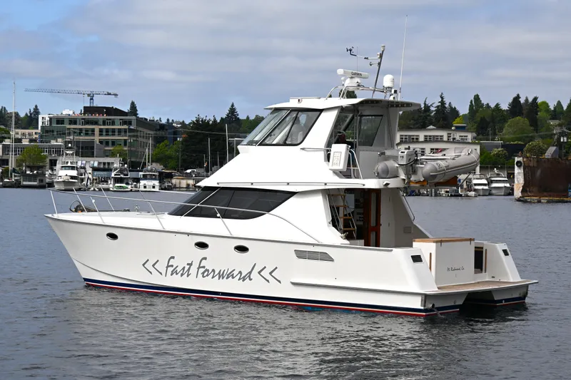 Slide: The Image of 2002 Roger Hill Power Cat 41.4 yacht on water, featuring sleek design and modern amenities. - 109