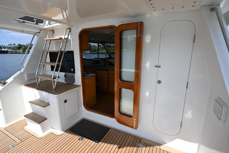 Slide: The Image of Interior view of 2002 Roger Hill Power Cat 41.4 with wooden door and ladder. - 12