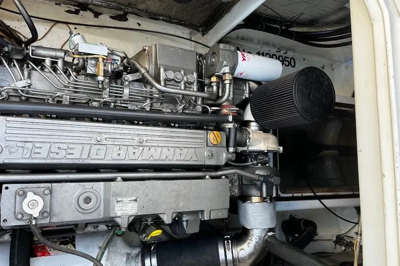 Slide: The Image of Engine compartment of a 2002 Roger Hill Power Cat, featuring a Yanmar diesel engine. - 120