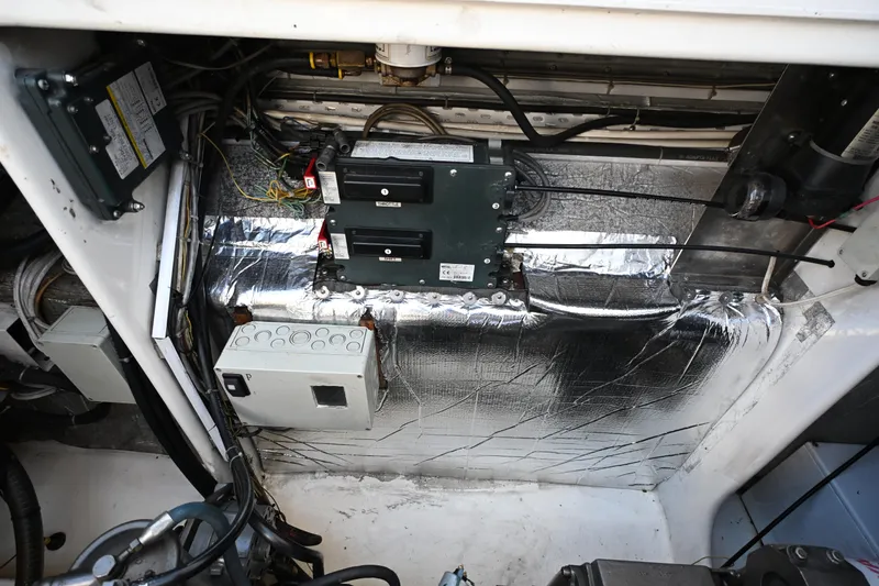 Slide: The Image of Engine room of 2002 Roger Hill Power Cat with electrical components and wiring. - 122