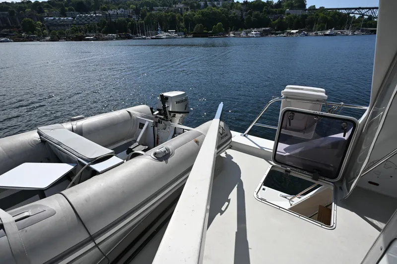 Slide: The Image of 2002 Roger Hill Power Cat 41.4 with inflatable boat and Honda motor on calm water. - 31