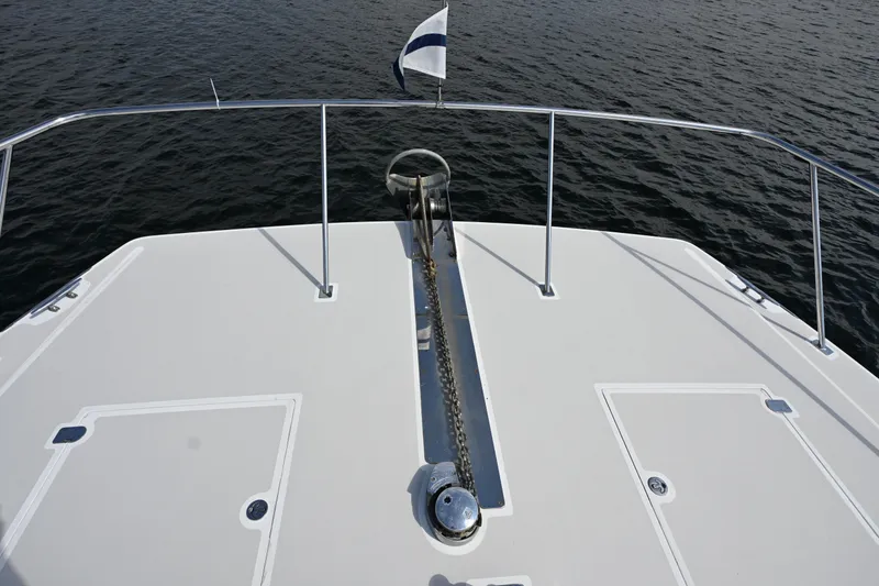 Slide: The Image of Bow view of 2002 Roger Hill Power Cat 41.4, featuring anchor and railing over water. - 37