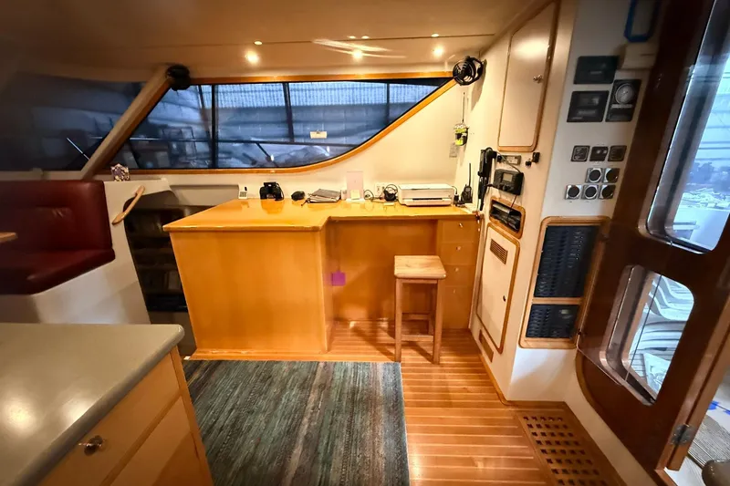 Slide: The Image of Interior of 2002 Norris Custom Motor Catamaran 41.4, featuring wooden cabinetry and seating. - 49