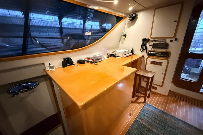 Slide: The Image of Norris Custom Motor Catamaran 41.4 with wooden desk and stool. - 50