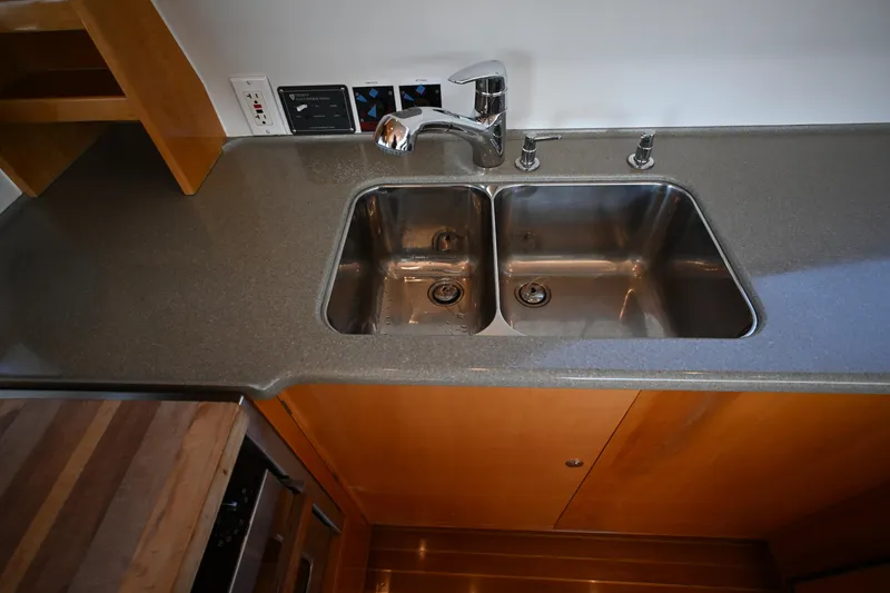 Slide: The Image of Stainless steel double sink in a 2002 Roger Hill Power Cat kitchen. - 55
