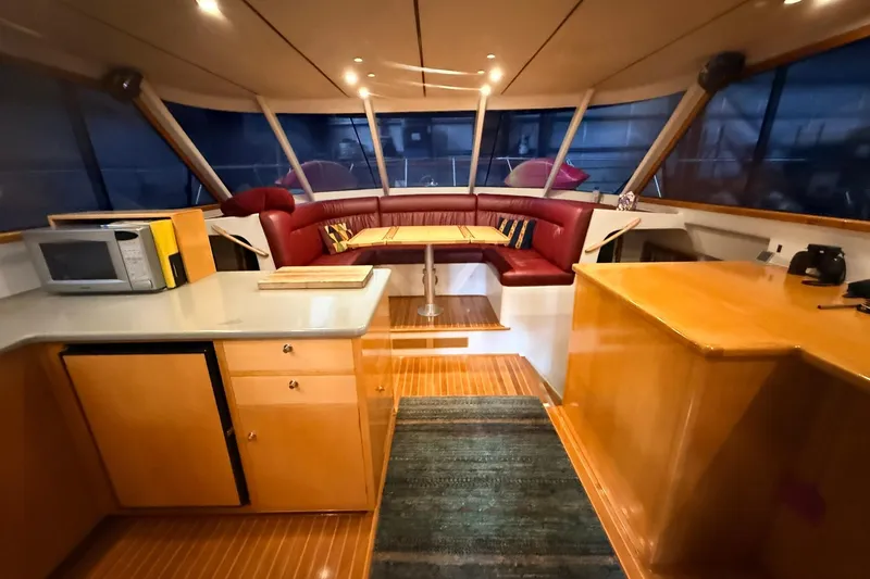 Slide: The Image of Luxurious interior of 2002 Norris Custom Motor Catamaran 41.4 with modern kitchen and seating area. - 57