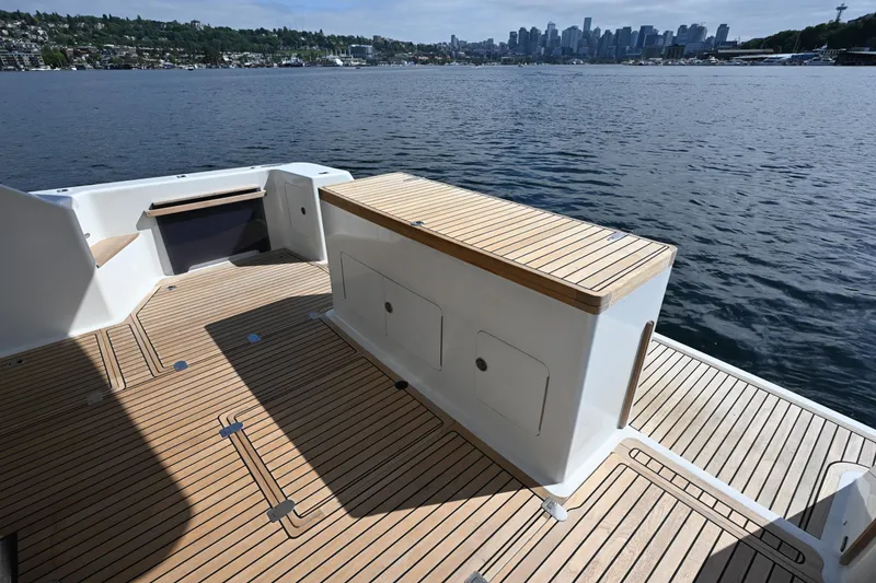 Slide: The Image of Deck view of 2002 Roger Hill Power Cat 41.4, overlooking water and city skyline. - 6