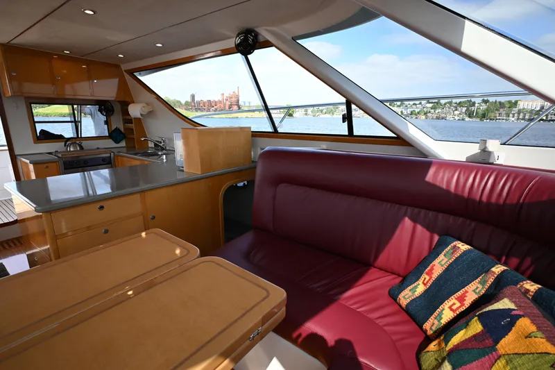 Slide: The Image of Luxurious interior of 2002 Roger Hill Power Cat 41.4 with kitchen and seating area, overlooking water. - 69