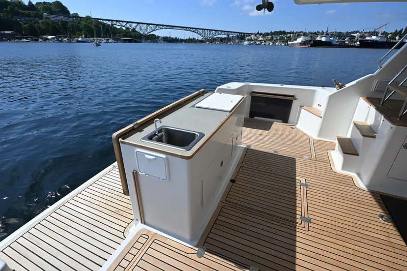 Slide: The Image of Deck view of 2002 Roger Hill Power Cat 41.4, featuring outdoor sink and scenic waterfront. - 7
