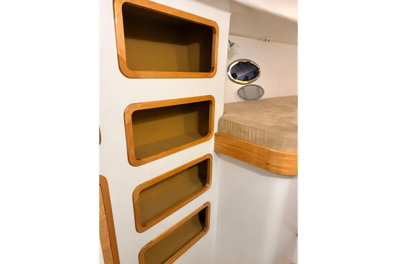 Slide: The Image of Interior of 2002 Norris Custom Motor Catamaran 41.4 with built-in shelves and bed. - 75